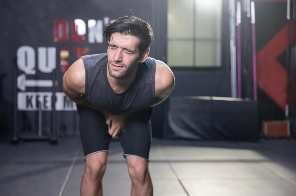 src-103777-groin-strain-hero Athlete holding his groin in pain from an adductor strain